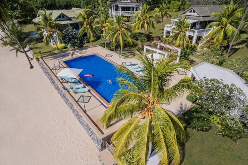 an aerial view of a house with a swimming pool at Villa Nirvana - Beachfront Tropical Chic 4BR Haven in Cape Panwa, Phuket in Ban Ao Makham