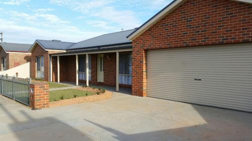 a brick house with two garage doors on it at Numurkah Self Contained Apartments - The Saxton in Numurkah