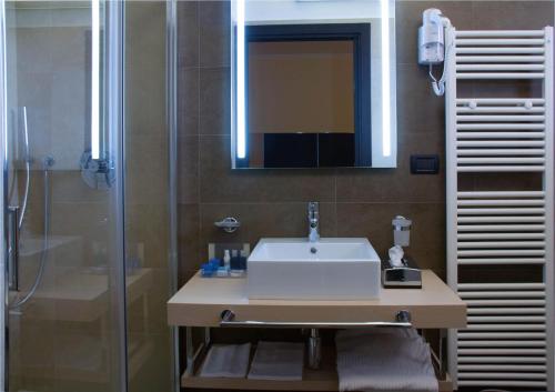 a bathroom with a sink and a shower at Hotel Imperial in San Benedetto del Tronto