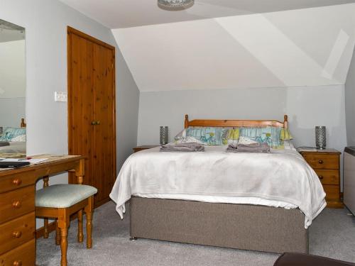 a bedroom with a bed with a desk and a chair at Cider Cottage - Uk11861 in North Tamerton