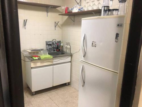 a kitchen with a white refrigerator and a sink at Azul Photo Studio & Apartment in Mexico City
