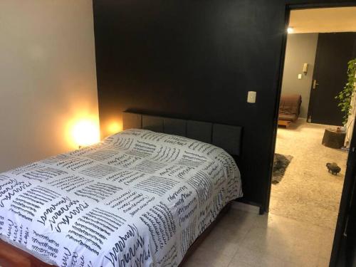 a bedroom with a bed with a white comforter at Azul Photo Studio & Apartment in Mexico City