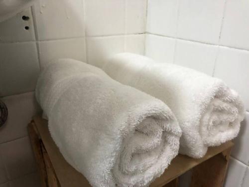 a pile of towels sitting on a shelf in a bathroom at Azul Photo Studio & Apartment in Mexico City