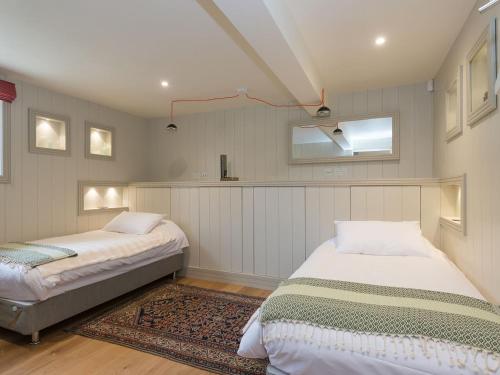 a bedroom with two beds and a window at The Old Surgery in Charlton