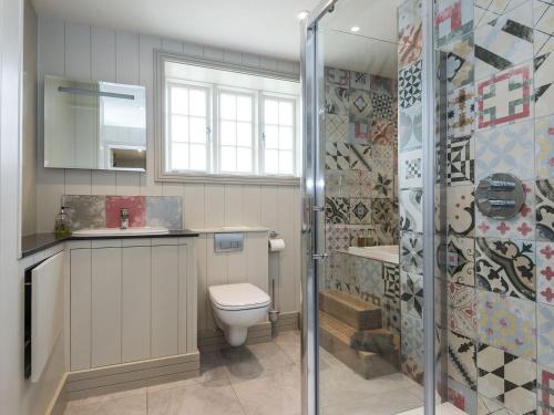 a bathroom with a toilet and a sink and a shower at The Old Surgery in Charlton