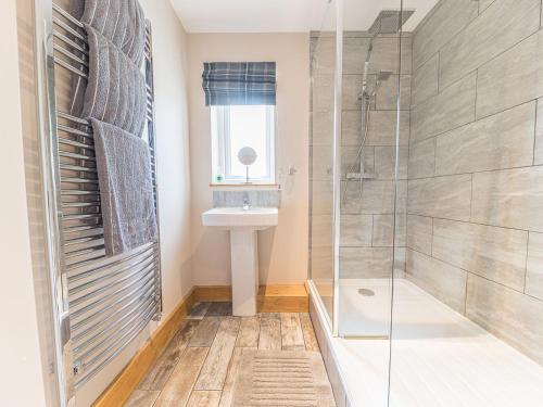 a bathroom with a shower and a sink at The Lodge in Dalton in Furness