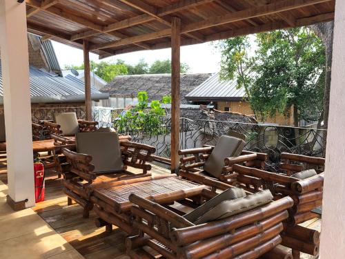 a deck with chairs and tables on a patio at Tipolo Beach Resort in Moalboal