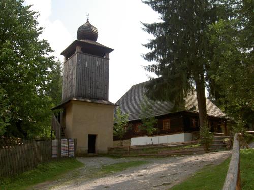 an old barn with a tower on the side of it at Drevenica Traditional Cottage Old Centre in Zuberec