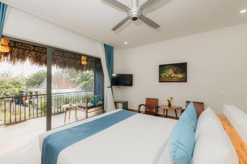 a bedroom with a bed and a balcony at Ngoc An Bang Villa in An Bang