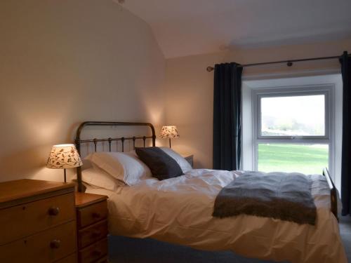 a bedroom with a large bed with a window at North View in Bradwell
