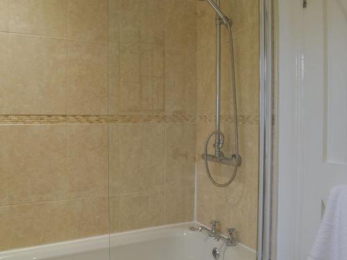 a bathroom with a shower and a bath tub at North View in Bradwell