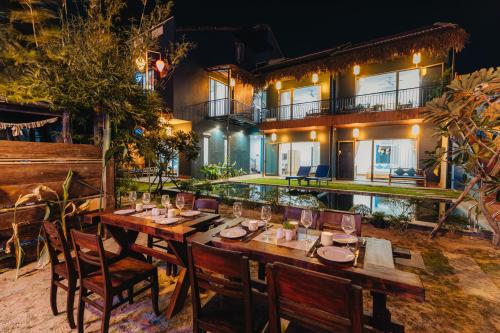 a restaurant with a table and chairs in front of a building at Ngoc An Bang Villa in An Bang