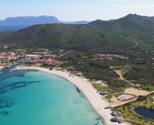 an aerial view of a beach and the ocean at Colonna Beach Hotel Marinella in Marinella