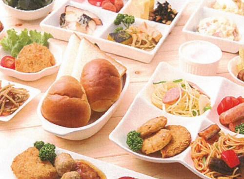 a table with many plates of food on it at Hotel FRENTE HIRONO in Hirono