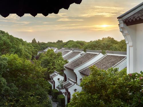 a row of roofs of houses with trees at Banyan Tree Hangzhou in Hangzhou
