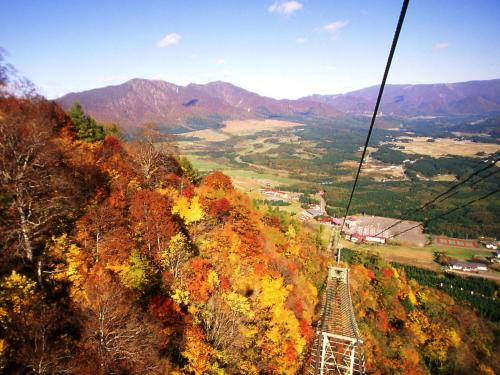 a gondola ride up a mountain in the fall at Hotel Onikoube in Osaki