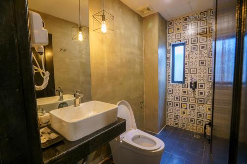 a bathroom with a sink and a toilet at The Rabbit Hole Hotel & SPA in Siem Reap