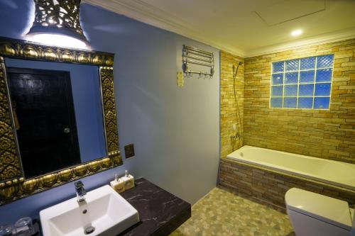 a bathroom with a sink and a bath tub at The Rabbit Hole Hotel & SPA in Siem Reap