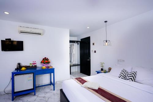 a bedroom with a bed and a blue table at The Rabbit Hole Hotel & SPA in Siem Reap