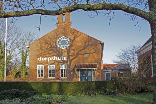 a brick building with the words crockholes on it at Dorpslogement Pieterburen in Pieterburen