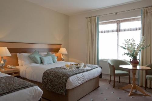 Postel nebo postele na pokoji v ubytování Ard Ri House Hotel