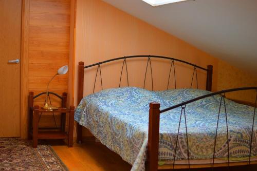 a bedroom with a bed with a metal frame at Kotedzas Melnrageje in Klaipėda