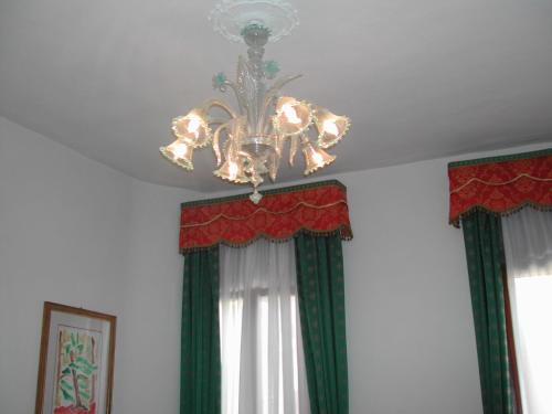 a chandelier hanging from a ceiling in a room at Ca' Derai in Venice