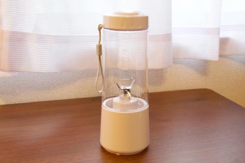 a white blender sitting on top of a table at だるまマンション901 in Naha