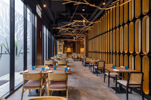 a row of tables and chairs in a restaurant at M Resort & Hotel Kuala Lumpur in Kuala Lumpur