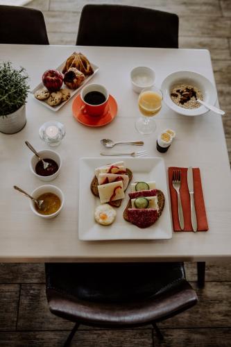 a table with a plate of breakfast food on it at Bakkalandet Hotel in Kolvereid