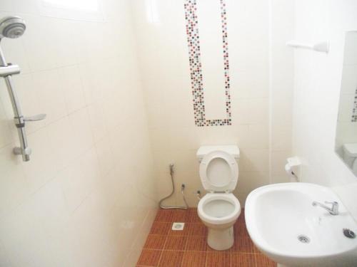 a bathroom with a toilet and a sink at Na Chaidej hotel in Suratthani
