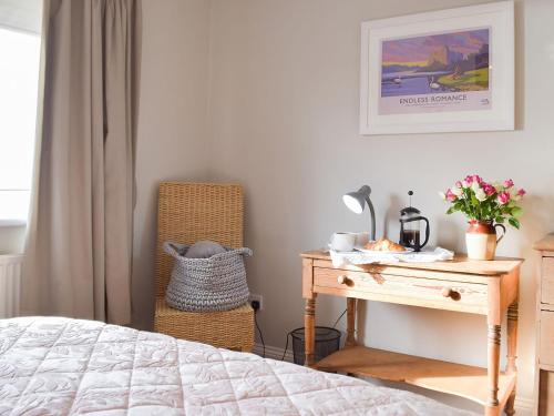 a bedroom with a bed and a desk and a chair at The Hays in Burton