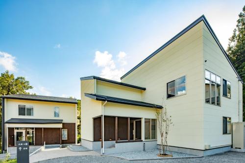 a modern house with white at CURIO Shirakawago in Shirakawa
