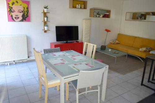 un salon avec une table et un canapé dans l'établissement F3 climatisé-terrasse 30 m2- Parking-Antigone, à Montpellier