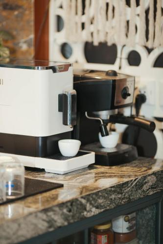a coffee maker sitting on top of a counter at Aroma Garden Suites Hoi An in Hoi An