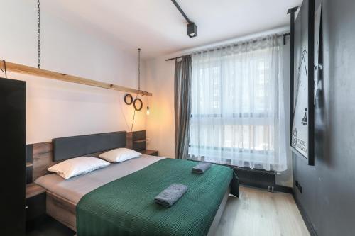 En eller flere senger på et rom på Apartament z Ogródkiem Gdańsk Stare Miasto