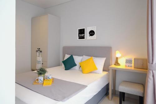 a small bedroom with a bed and a desk at TwoSpaces Living at Zena Mozia in Tegal
