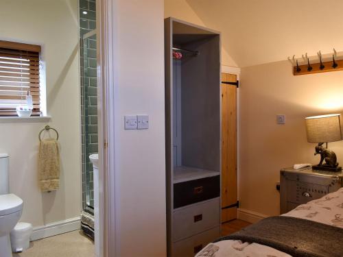 a bathroom with a shower and a toilet and a sink at Sparrow - Uk30747 in Acton Trussell