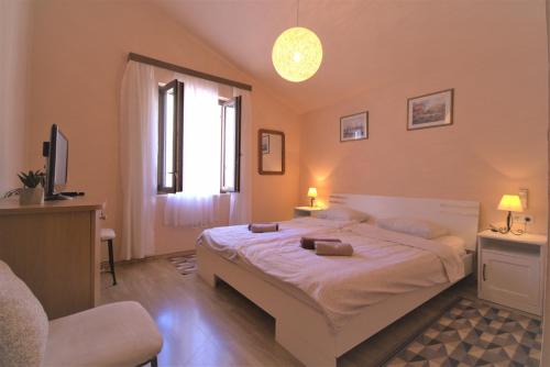 a bedroom with a large bed and a window at Apartment Nostra Casa Orsera in Vrsar