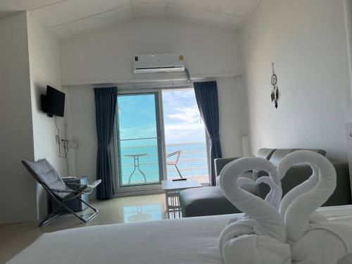 a hotel room with a bed with swans on it at Pi3 Beach Resort in Lamai