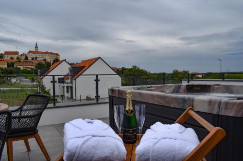a bottle of champagne on top of a balcony at Apartmány Pod Novou in Mikulov
