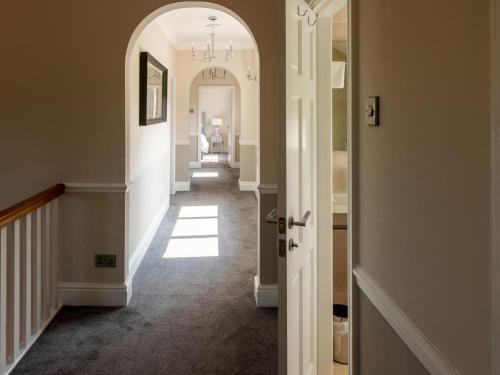 a hallway of a home with an archway at Deneville in Heighington