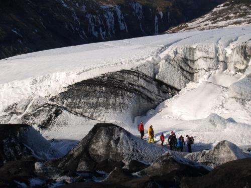 a group of people standing in front of a glacier at Vestri Pétursey in Vestri Pétursey
