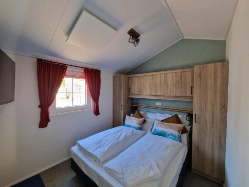 a bedroom with a bed and a window at Seaside-Resort in Geiselwind