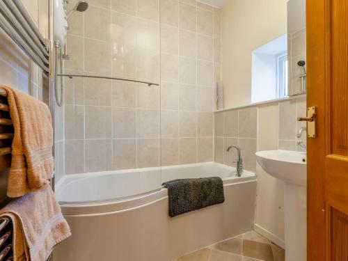 y baño con bañera y lavamanos. en The Milking Shed - Uk30436, en Kingsbury Episcopi