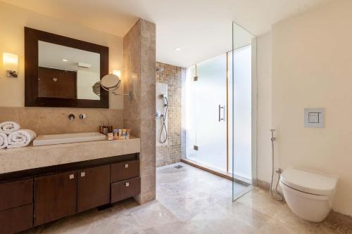 a bathroom with a toilet and a sink and a shower at StayVista at Bella Orion with Pvt Pool- North Goa in Calangute