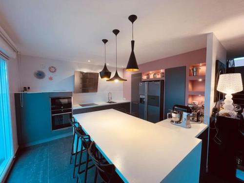 a kitchen with a white counter and blue at Villa Metz / Amnéville 200m2 in Vigy
