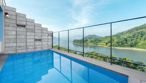 a swimming pool with a view of a river at Bayclub in Namhae