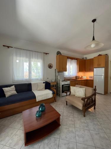 a living room with a couch and a table at G&S Beach House in Flogita