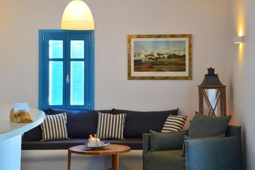 a living room with a couch and a table at Miramare Hotel in Chora Folegandros